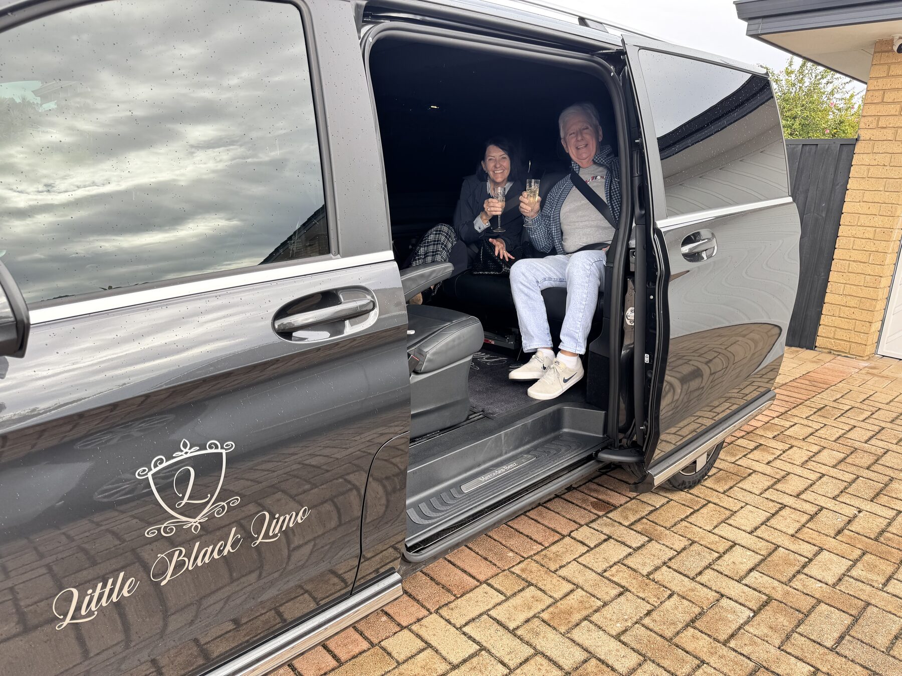 Couple toasting champagne in the van